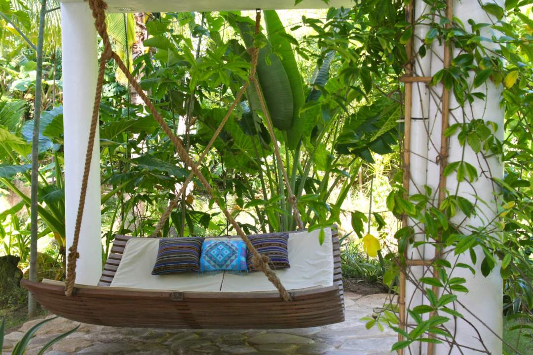 chillout bed hanging underneath jungle villa