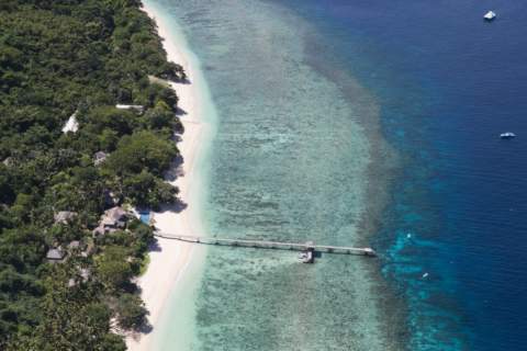 Island pier and boats aerial photos