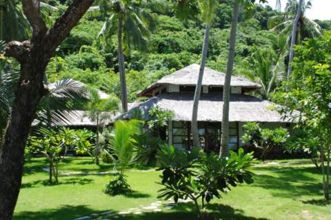 tropical island beach cottages surrounded by jungle