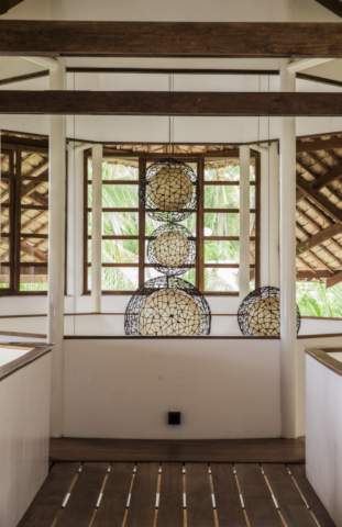 chandelier surrounded by incredible wooden architecture