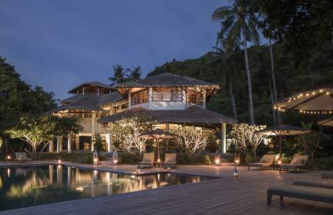 lodge and pool lit up in the evening