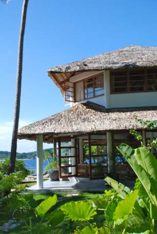 Island lodge surrounded by vibrant green plants