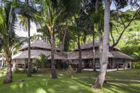 beachside villas surrounded by palm trees