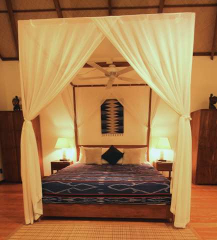 king sized bed in tropical villa