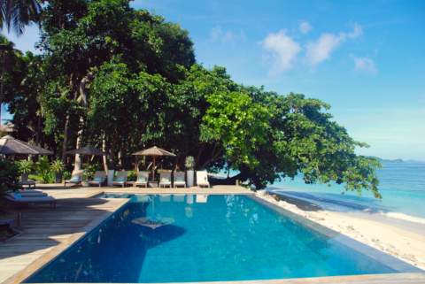beach side pool with sunbeds