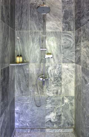 shower room surrounded in grey blue marble
