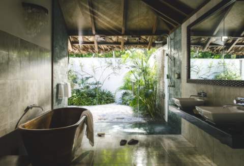 wooden bathtub in beautiful marble bathroom